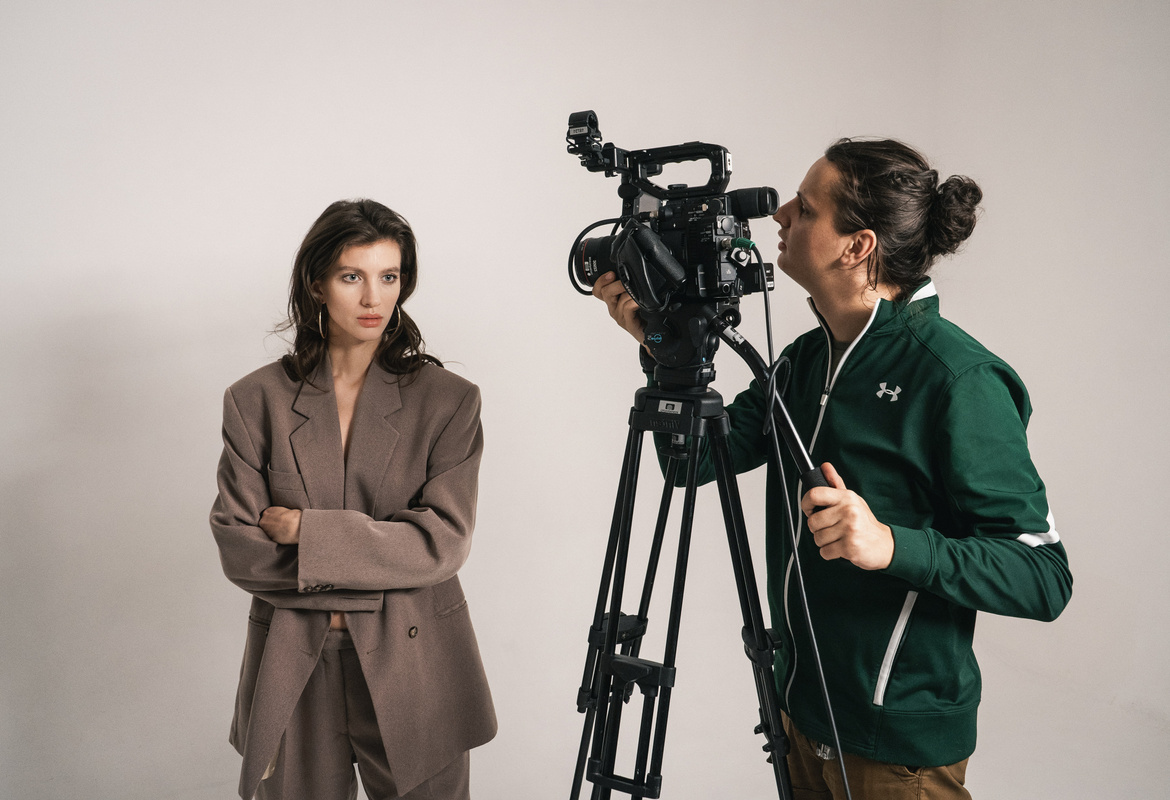 Female Model Being Shot by a Videographer at the Studio